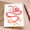 Lifestyle photography - Illustrated greeting card featuring pink snake design.